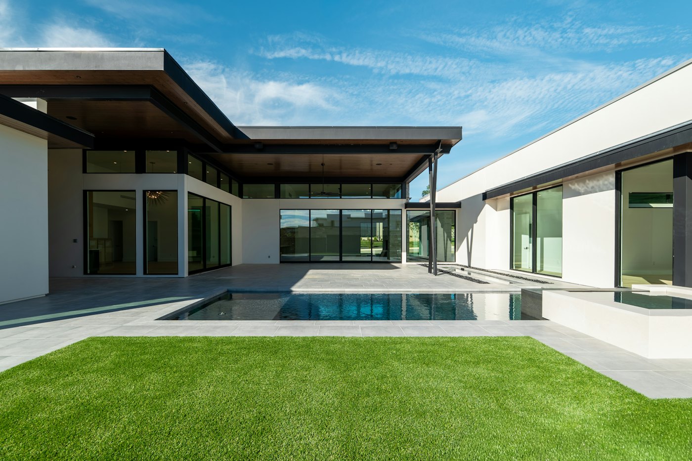 Modern house with a swimming pool and green lawn