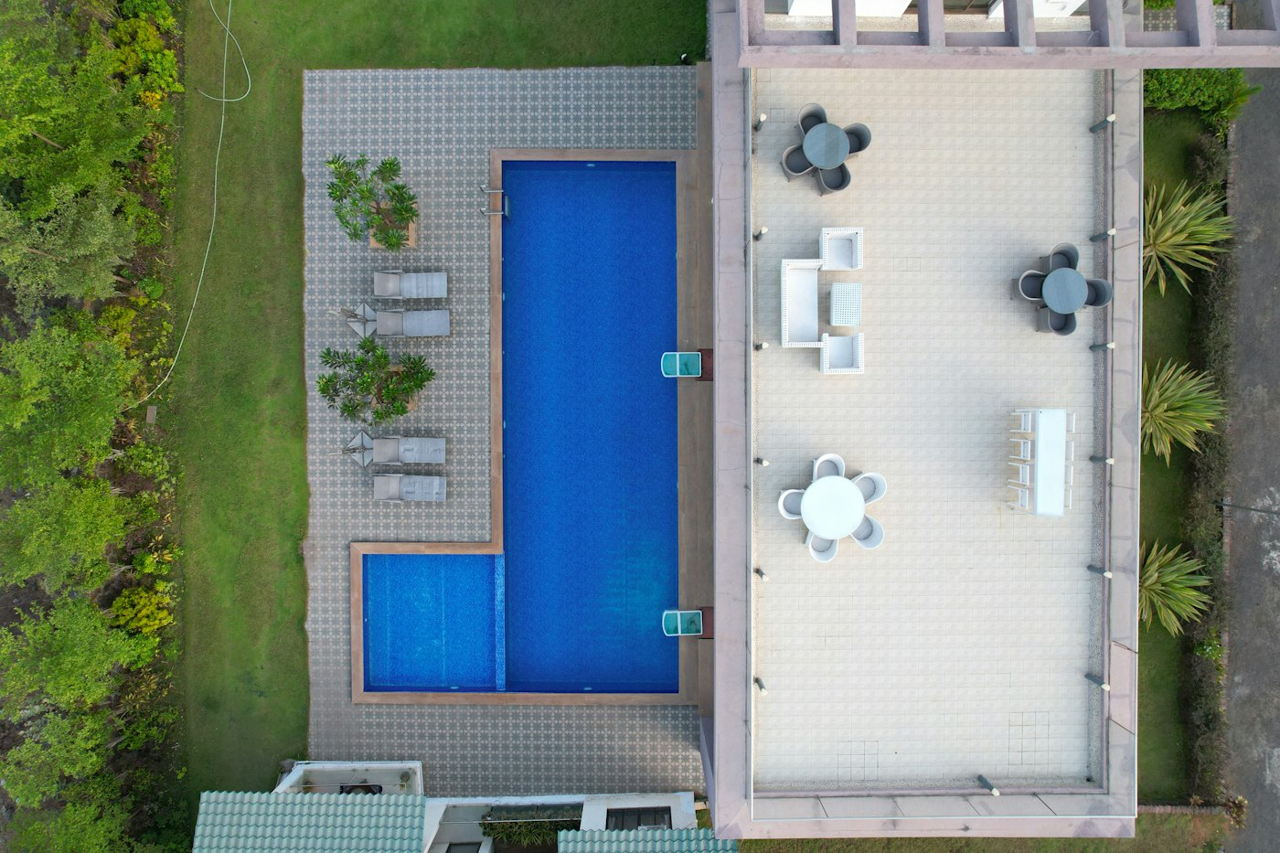 Aerial view of a pool, deck and patio